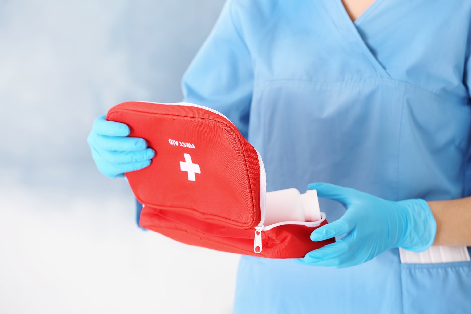 PPE first aid supplies for workplace safety, including bandages, gloves, masks, and disinfectants.
